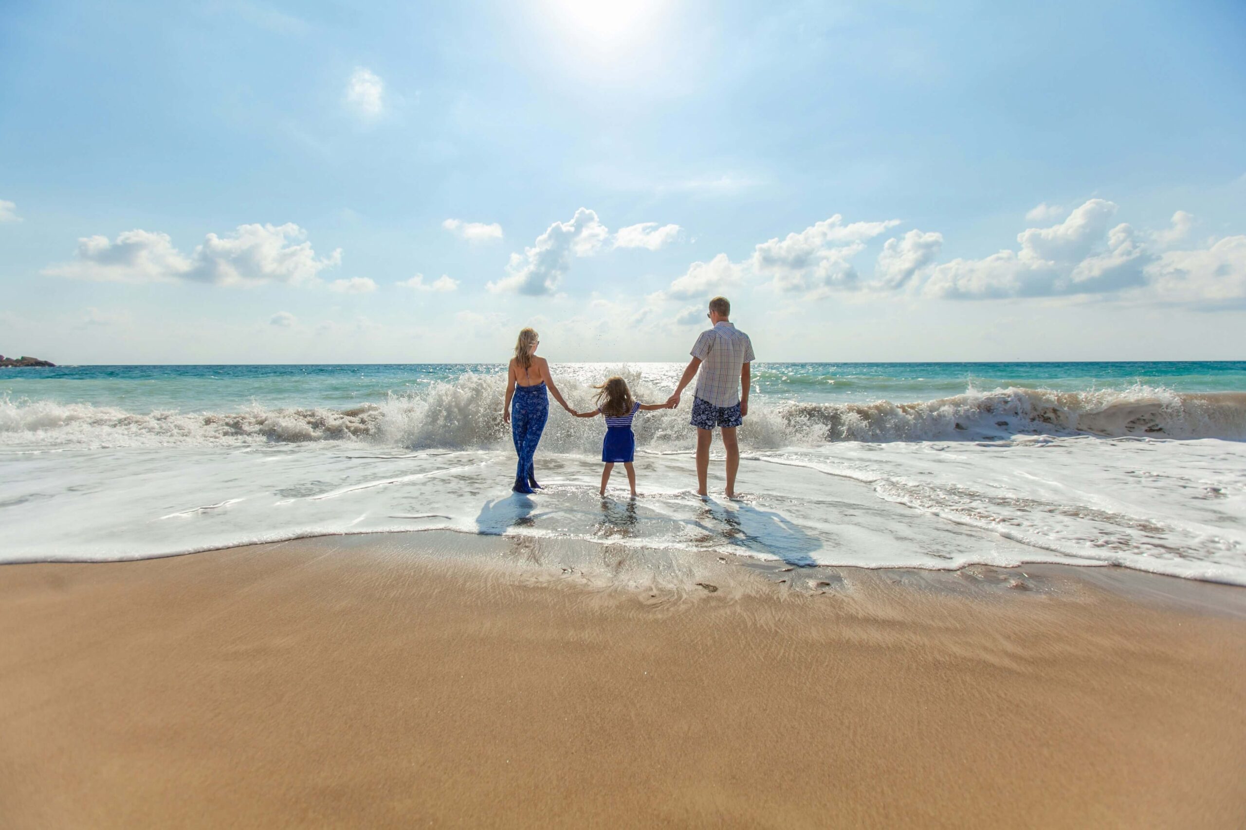 a happy and healthy family on the beach enjoying the sun.